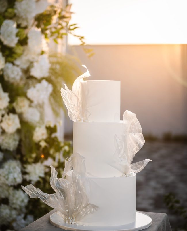 Trendy,Cake,With,Light,At,Sunset.,Wedding,Cake,On,Background